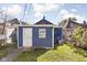 Blue detached garage with a white door in the backyard at 1526 Lawton Ave, Indianapolis, IN 46203