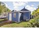 Blue detached garage with a white door in the backyard at 1526 Lawton Ave, Indianapolis, IN 46203