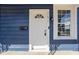 White front door and blue exterior at 1526 Lawton Ave, Indianapolis, IN 46203