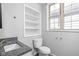 Clean bathroom with granite vanity and built-in shelving at 1526 Lawton Ave, Indianapolis, IN 46203