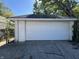 Detached single-car garage with a white roll-up door at 1526 Lawton Ave, Indianapolis, IN 46203