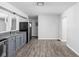 Open concept kitchen with gray cabinets and vinyl flooring at 1526 Lawton Ave, Indianapolis, IN 46203
