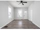 Hardwood floor living room with multiple windows and a ceiling fan at 1526 Lawton Ave, Indianapolis, IN 46203