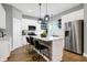 Modern kitchen with white cabinets, a kitchen island, and stainless steel appliances at 515 Orange St, Indianapolis, IN 46203