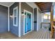 Inviting front entrance with a bright blue door and a wooden porch at 515 Orange St, Indianapolis, IN 46203