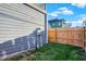 Side view of a gray house with a wooden fence and grassy area at 515 Orange St, Indianapolis, IN 46203