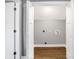 Bright laundry room with wood flooring and built-in shelving at 515 Orange St, Indianapolis, IN 46203