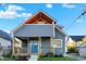 Modern two-story home with gray siding, blue door and a front porch at 515 Orange St, Indianapolis, IN 46203