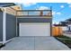 Garage with deck above and concrete driveway at 515 Orange St, Indianapolis, IN 46203