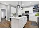Modern kitchen with white cabinets, a kitchen island and hardwood floors at 515 Orange St, Indianapolis, IN 46203
