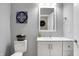 Clean bathroom with white vanity, toilet, and a framed mirror at 515 Orange St, Indianapolis, IN 46203