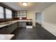 Galley kitchen with gray cabinets and black flooring at 712 W Queen St, Muncie, IN 47303