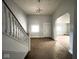 Living room with staircase and view to additional rooms at 712 W Queen St, Muncie, IN 47303