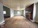 Spacious living room featuring hardwood floors and a brick fireplace at 712 W Queen St, Muncie, IN 47303