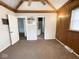 Spacious bedroom with wood paneling and a view of another room at 712 W Queen St, Muncie, IN 47303