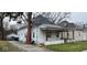 Side view of the house, showcasing the exterior details and landscaping at 712 W Queen St, Muncie, IN 47303