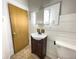 Bathroom with vanity, mirror, and wood-paneled walls at 712 W Queen St, Muncie, IN 47303