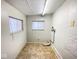Laundry room with tile floor and two windows at 712 W Queen St, Muncie, IN 47303