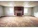 Living room with brick fireplace and large windows at 712 W Queen St, Muncie, IN 47303