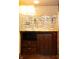Basement bar with granite countertop and glass shelving at 6205 Bramshaw Rd, Indianapolis, IN 46220