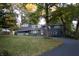 Ranch home with dark blue exterior and landscaping at 6205 Bramshaw Rd, Indianapolis, IN 46220