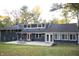 Dark blue home with a large backyard and patio at 6205 Bramshaw Rd, Indianapolis, IN 46220