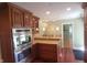 Modern kitchen with hardwood floors and stainless steel appliances at 6205 Bramshaw Rd, Indianapolis, IN 46220