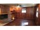Spacious living room featuring hardwood floors, a brick fireplace, and built-in shelving at 6205 Bramshaw Rd, Indianapolis, IN 46220