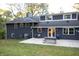 Backyard view of dark blue home with patio and picnic table at 6205 Bramshaw Rd, Indianapolis, IN 46220