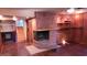 Hardwood floors, brick fireplace, and built-in shelving highlight this living room at 6205 Bramshaw Rd, Indianapolis, IN 46220