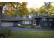 Ranch home with dark blue exterior and landscaping at 6205 Bramshaw Rd, Indianapolis, IN 46220