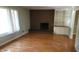Living room with hardwood floors and brick fireplace at 6205 Bramshaw Rd, Indianapolis, IN 46220
