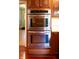 Stainless steel double oven built into wood cabinets at 6205 Bramshaw Rd, Indianapolis, IN 46220