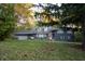 Ranch home with dark blue exterior and landscaping at 6205 Bramshaw Rd, Indianapolis, IN 46220
