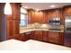 Kitchen with wood cabinets and stainless steel appliances at 6205 Bramshaw Rd, Indianapolis, IN 46220