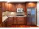 Kitchen with wood cabinets and stainless steel appliances at 6205 Bramshaw Rd, Indianapolis, IN 46220