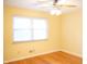 Bedroom with hardwood floors and a large window at 6205 Bramshaw Rd, Indianapolis, IN 46220