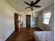Bedroom with hardwood floors, damaged walls, and a mattress at 548 Central N Ct, Indianapolis, IN 46205