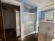 Small bathroom with shower, partial wall, and wood floor at 548 Central N Ct, Indianapolis, IN 46205