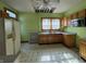 Kitchen with wood cabinets, light green walls, and linoleum floor at 548 Central N Ct, Indianapolis, IN 46205