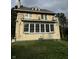 Two-story house with yellow stucco exterior and sunroom at 548 Central N Ct, Indianapolis, IN 46205