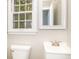 Small bathroom with white vanity, toilet and a window at 3226 W 46Th St, Indianapolis, IN 46228