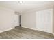 Bedroom with gray vinyl flooring, white closet doors and door to hallway at 3226 W 46Th St, Indianapolis, IN 46228