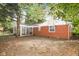 Rear view of house highlighting screened porch and yard at 3226 W 46Th St, Indianapolis, IN 46228