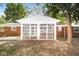 Screened porch with brick exterior and leafy green surroundings at 3226 W 46Th St, Indianapolis, IN 46228