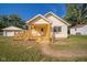Full front view of the house with a wooden deck and landscaping at 2682 E 150 S, Anderson, IN 46017