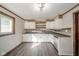 Kitchen with white cabinets, wood backsplash and dark floors at 2682 E 150 S, Anderson, IN 46017