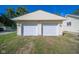 Detached two-car garage with white doors and light-yellow exterior at 2682 E 150 S, Anderson, IN 46017
