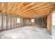 Unfinished garage interior with exposed framing, wiring, and concrete floor at 2682 E 150 S, Anderson, IN 46017