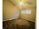 Bright bedroom featuring neutral walls and carpeting, ceiling fan at 4839 Alameda Rd, Indianapolis, IN 46228